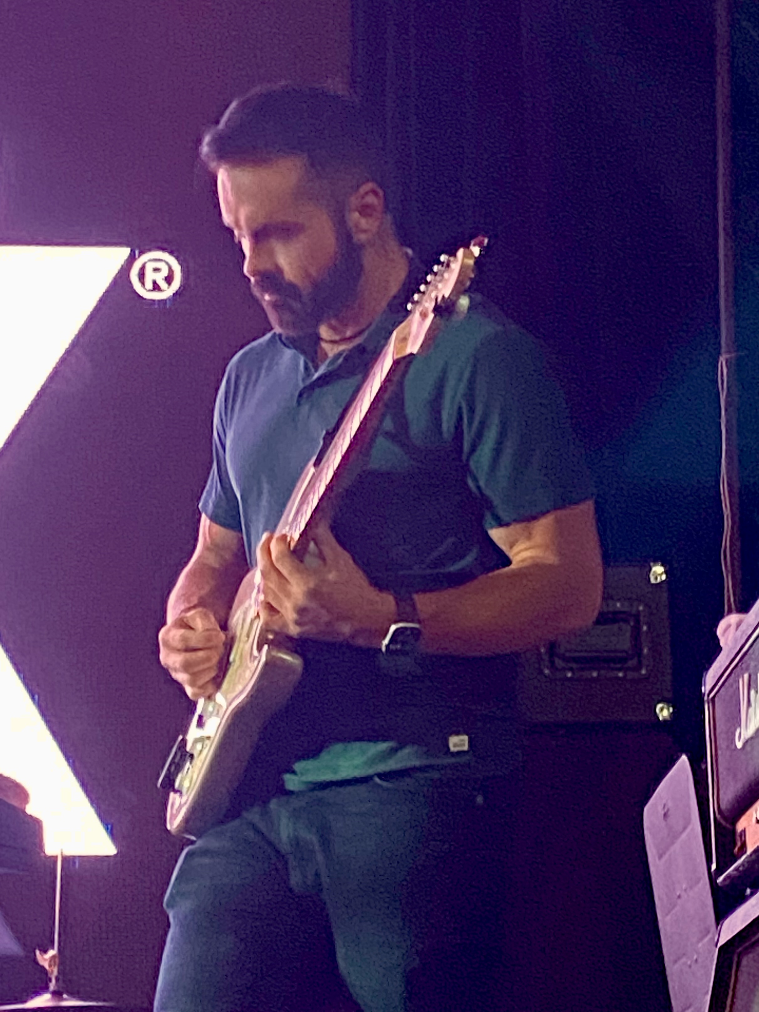 Joel Farthing playing guitar on stage