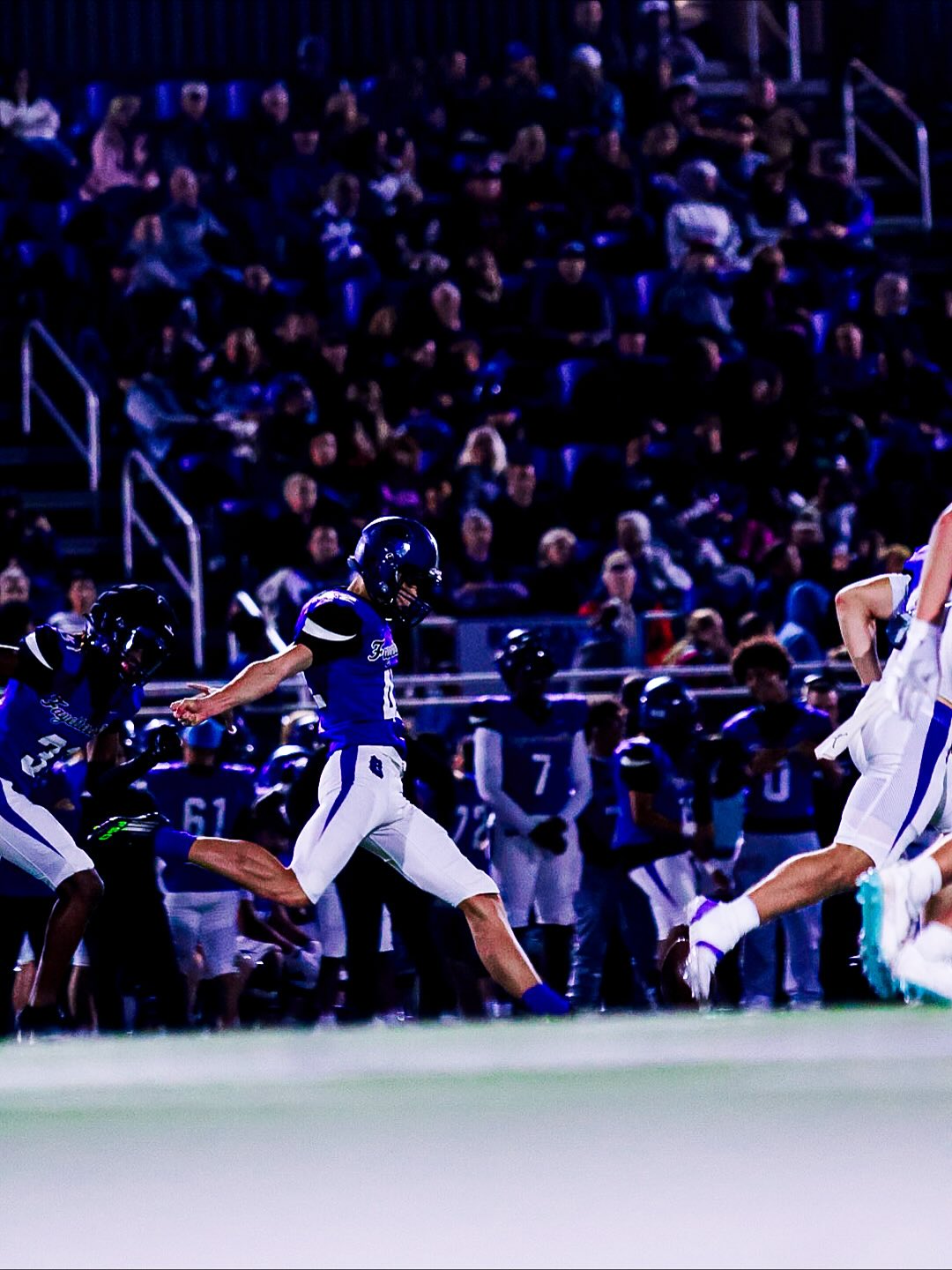 Ethan Farthing kicking under the stadium lights for Fayetteville High School.